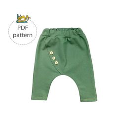 a green pants with buttons on the front and bottom, sitting in front of a white background