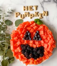 a plate that has some fruit on it and the words hey pumpkin spelled in wood letters