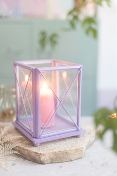 a candle is sitting on top of a rock