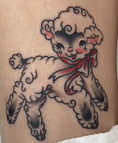 a tattoo design of a sheep with a red ribbon around its neck and feet, on the leg