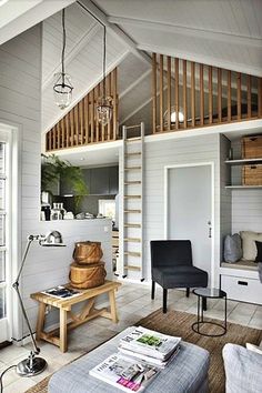 a living room filled with furniture and a staircase leading to the top floor above it