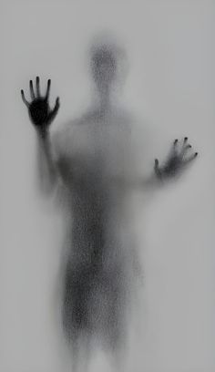 a person with their hands out in front of a foggy background, while the image appears to be black and white