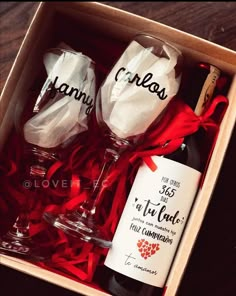 two wine glasses in a box with red ribbon