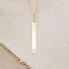 This is a gorgeous and trendy 14K gold engravable bar necklace, shown with a natural 0.03ct diamond. This is the perfect necklace to be worn on its own or layered with some of your favorite pieces. Please note that there are other available stone options. Feel free to reach out for pricing through email. NECKLACE DETAILS: Materials: 14K gold cable necklace with a single diamond in a polished finish. Stone Details: - 0.03ct 2mm natural diamond Pendant dimensions: 42x4.38 mm Chain Length: 18 Inche Minimalist Diamond Rectangular Pendant Jewelry, Everyday Gold Bar Necklace With Diamond, Minimalist Yellow Gold Bar Necklace With Diamond Accents, Minimalist Diamond Accents Bar Necklace As Gift, Gold Minimalist Diamond Bar Necklace, Minimalist Gold Diamond Bar Necklace, Minimalist Diamond Accents Bar Necklace Gift, Minimalist Bar Necklace With Diamond Accents As Gift, Minimalist Bar Necklace With Diamond Accents For Gift