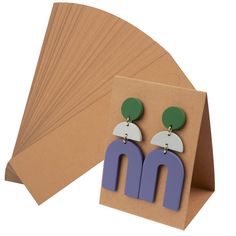 PRICES MAY VARY. HIGH QUALITY - Our Earring Display Cards are made of high quality paper material with pre-cut holes and pre-scored which are very easy to use. SIZE - Each standing earring card measures 6.5 x 5 x 8.5 cm/2.6 x 2 x 3.4 Inch. UNIQUE DESIGN - These display cards are the perfect gift for anyone who needs to display their earrings vertically. They stand securely on the table without the use of a display stand. EASY TO OPERATE - Each earring card is pre-scored so it's easy to fold, ass Earring Display Cards, Jewelry Display Cards, Laser Cut Earrings, Earring Card, Packaging Supplies, Earring Holder, Paper Material, Small Organization, Earring Cards