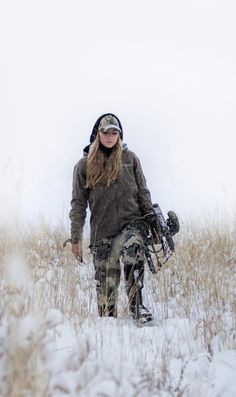 a woman walking in the snow with her skis