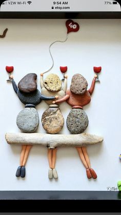 a group of small figurines sitting on top of a white board with rocks and candles