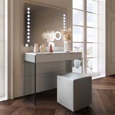 a white vanity with lights on it and a stool in front of the mirror next to it