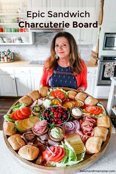 a woman standing in front of a large platter of food