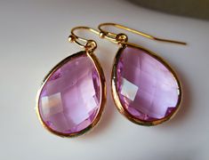 Elegant and fancy jewelry .. gold earrings ... lavender amethyst framed glass jewelry ... Elegant faceted framed light lavender amethyst glass drops, dangle beneath gold plated French earring wires. The total length is 32mm (1.25inches). All metal is gold plated brass. https://www.etsy.com/shop/karmelidesigns Elegant Purple Jewelry With Ear Wire, Faceted Drop Earrings As Gift, Elegant Pink Faceted Earrings, Pink Faceted Earrings For Gift, Lavender Briolette Earrings For Gift, Elegant Faceted Crystal Earrings For Gift, Elegant Pink Gold Jewelry With Ear Wire, Lavender Drop Earrings For Gifts, Lavender Briolette Jewelry Gift