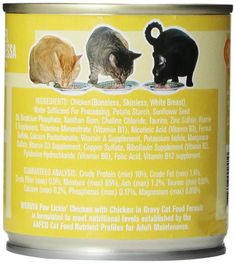 an open can of canned cat food with three cats eating out of it's top