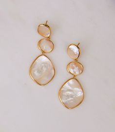 Make a statement with these elegant tier drop earrings in stunning mother of pearl set in plated gold. Each piece is handcrafted to bring out the natural artistry of its particular stone. 2" drop, .75" width Post back 18 karat plated gold Bride Earrings Gold, Mother Of The Bride Jewelry, Modern Pearl Jewelry, Mother Of Pearl Jewelry, Bridal Earrings Drop, Pearl Earrings Wedding, Wedding Earrings Drop, Mother Of Pearl Earrings, Bride Earrings