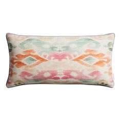 an orange, pink and green pillow on a white background