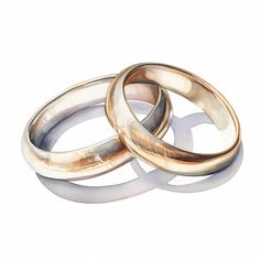 two gold wedding rings sitting next to each other