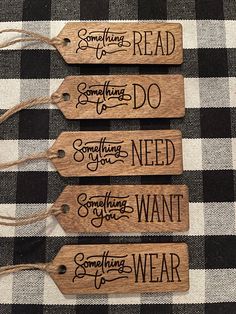 three wooden tags that say something to do, something you want and something to wear