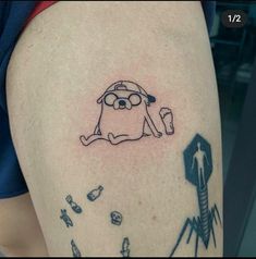 a cartoon character tattoo on the thigh