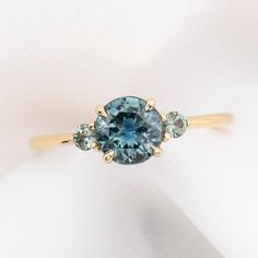 a blue diamond ring with three diamonds on it