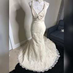 a white wedding dress on display in a room