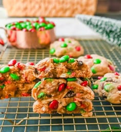 cookies with candy and m & ms on a cooling rack, ready to be eaten