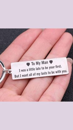 a hand holding a keychain that says to my man i was a little late to be your first but i want all of my lasts to be with you