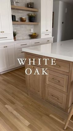 a kitchen with white cabinets and wood floors is featured in this ad for oak flooring