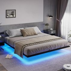 a bed with blue lights underneath it in a room