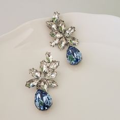 "Elegant Vintage style Bridal Earrings. Made with high-quality Crystal rhinestones in light blue and clear crystals. Gorgeous and elegant floral-inspired drops. Pair them with a cocktail dress or an over-sized sweater for an everyday look. Rhodium silver plated 2\" length, 1\" width Glass crystals Surgical steel posts, hypoallergenic" Elegant Light Blue Crystal Earrings For Party, Blue Crystal Earrings For Wedding, Blue Rhinestone Crystal Earrings For Wedding, Blue Statement Earrings, Blue Chandelier, Bridal Statement Earrings, Crystal Cuff Bracelet, Clear Crystals, Large Crystals