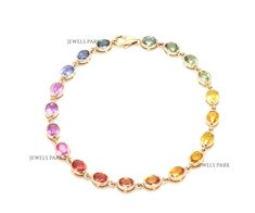 Rainbow sapphire oval cut bezel set tennis bracelet gold | Natural 6-7ct multi sapphire rainbow bracelet gold | Raimbow ombre bracelet gold STONE DETAILS : ✦ Stone : Rainbow Sapphire ✦ Stone Type : Natural ✦ Stone Size : 5x4MM ✦ Stone Shape : Oval cut ✦ Number of stones : 20 ✦ Stone Weight : 6-7 carats ✦ Stone Grade : AAAA METAL DETAILS : ✦ Metal : Solid 14K / 18K Gold ✦ Metal Colour : Yellow / White / Rose Gold ✦ Setting : Prong Setting ✦ Bracelet Box : Yes SHIPPING DETAILS : ✦ Shipped via : UPS ✦ Production time : 10-12 days ✦ Delivery time : 7-8 days ✦ Expedited shipping : Available ✦ Expedited shipping service : UPS ✦ Expedited shipping time : 5 days ✦ Expedited shipping cost : 70$ CUSTOMISATION DETAILS : We can customize any piece of fine jewelry. You can simply message us on Etsy or Rainbow Oval Multi-stone Jewelry, Rainbow Colored Oval Jewelry, Formal Rainbow Gemstone Jewelry, Tennis Bracelet Gold, Ombre Bracelet, Eternity Bracelet, Rainbow Sapphires, Bracelet Box, Multi Sapphire