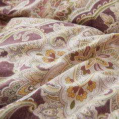 a close up view of a paisley pattern on a bed sheet or comforter cover