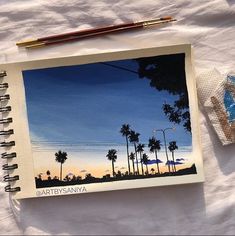 an open notebook sitting on top of a table next to a pencil and eraser