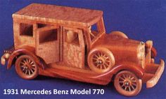 an old model car made out of wood on a blue background with the words merceds benz model 70