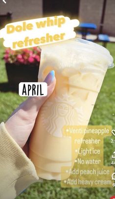 a woman holding up a starbucks drink with the words dole whip refresher