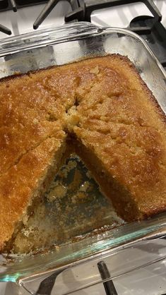 a cake that has been cut in half on a stove top with one slice taken out