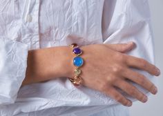 Our ROY G. BIV and gold Dropping Circles Bracelet is perfect on its own or paired with your favorite gold bracelets. Add style and happiness with this multi-colored semi-precious gemstone statement bracelet. Made of Genuine Garnet, Pink Chalcedony, Orange Chalcedony, Citrine, Prehnite, Blue Chalcedony and Purple Chalcedony Semi-Precious Gemstones Set in 14k Gold Vermeil from recycled .925 sterling silver and gold metals Dimensions: 3/4" Wide x 6 3/8" Long with a 2" Chain Extender *Please note th Yellow Gold Gemstone Bracelets For Party, Yellow Gold Gemstone Bracelet For Party, Luxury Multicolor Gemstones With Accents, Multicolor Stone Bracelets In Fine Jewelry Style, Formal Multicolor Natural Gemstones, Multicolor Gemstone Bracelets For Formal Occasions, Elegant Natural Stone Bracelets For Parties, Modern Multicolor Jewelry With Stones, Luxury Natural Stones Bracelets