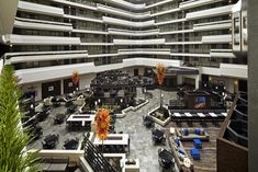 an atrium with tables and couches in it