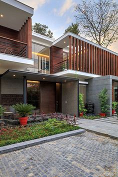 a modern house with large windows and wooden balconies