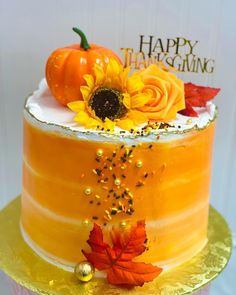 there is a cake decorated with sunflowers and autumn leaves on the top tier