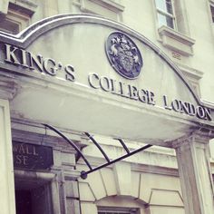 the king's college london sign is hanging above the entrance