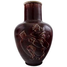 a brown vase with a horse and rider on it