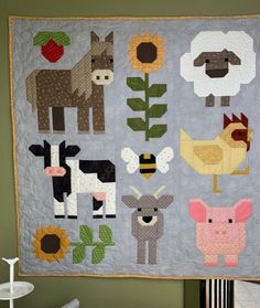 a quilted wall hanging with farm animals on it