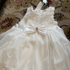 Beautiful Baby Girl White Dress New Never Used. It Is A Formal Dress For Kids! White Bow Tutu Dress For Summer, Spring Baptism Tutu Dress With Bow, Spring Baptism Princess Dress With Bow, Spring Princess Dress With Bow For Baptism, Summer White Princess Dress With Bow, White Sleeveless Princess Dress For Garden Party, Cute White Princess Dress For Baptism, White Princess Dress With Bow For Spring, Spring Princess Baptism Dress