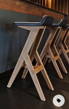 three wooden stools sitting next to each other