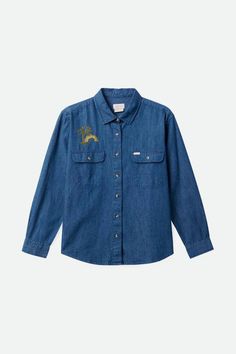 a denim shirt with embroidered animals on the chest