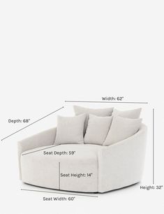 a white couch with pillows on it and measurements for the seat height, width, and back