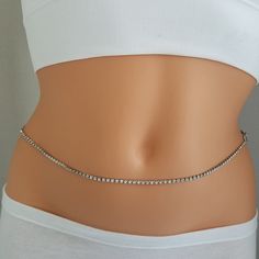 Rhinestones Belly Chain, Rhinestone Belt, Belly Chain, Gold Belly Chain, Silver Belly Chain Cast a dazzling glow over your natural curves with this amazing piece of jewellery piece. The belly chain features; ~Silver finish rhinestone chain ~Silver plated lobster clasp ~A beautiful leaf charm is added in the middle. ~Lenght is 24 inches with 4 inches adjustment. Please make sure that this bellychain is only for waist sizes 24 to 30 inches. Enter Azram Designd here: https://www.etsy.com/shop/Azram Elegant Silver Crystal Waist Chain, Silver Body Chain With Rhinestones In Crystal, Silver Crystal Waist Chain For Party, Elegant Silver Crystal Chain Belt, Silver Metal Body Chain With Rhinestones, Silver Crystal Body Jewelry With Sparkling Stones, Crystal Body Jewelry With Bling For Gift, Crystal Bling Body Jewelry As Gift, Belly Chain Body Jewelry