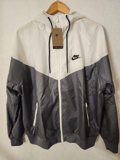 Nike Hooded Gym Outerwear, Nike Hooded Outerwear For Gym, Nike Casual Outdoor Sweatshirt, Sporty Hooded Jacket For Fall Sports, Fall Sportswear Hooded Jacket For Sports, Nike Long Sleeve Windbreaker With Pockets, White Nike Track Jacket For Outdoor Activities, Nike White Track Jacket For Outdoor Activities, Nike Sportswear Windbreaker With Moisture-wicking