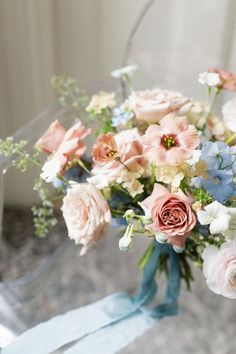 a vase filled with lots of flowers on top of a table