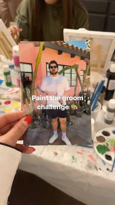 a person holding up a card that says paint the groom, challenge