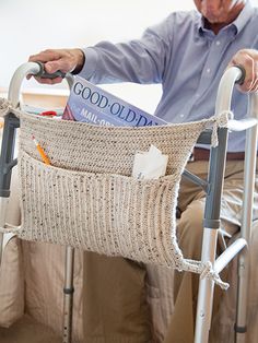 an elderly man sitting in a walker with his book