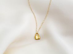 "Dainty lock necklace! The pendant is made of gold vermeil, which is heavy gold plating over sterling silver. Pair it with your favorite outfit! Layer with other necklaces, by or wear itself for a pop! . . . . . . . . . . . . . . . . . . . . . . . . . . . . . . . . . . . . . . . . . . NECKLACE + Length: 16\" + 2\" extender + Vermeil (18k gold plating over sterling silver) -or- sterling silver lock pendant: 8mm x 11mm + 14k gold filled -or- sterling silver chain, spring clasp, & findings LAYE Yellow Gold Chain Necklace With Gold Clasp As Gift, Everyday Gold Lock Jewelry, Everyday Gold Jewelry With Lock Detail, Gold Chain Necklace With Lock For Gift, Gold Lock Necklace As Gift, Yellow Gold Necklace With Lock As Gift, Lock Charm Necklace, Necklace Lock, Padlock Necklace